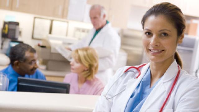 GP in reception with practice staff